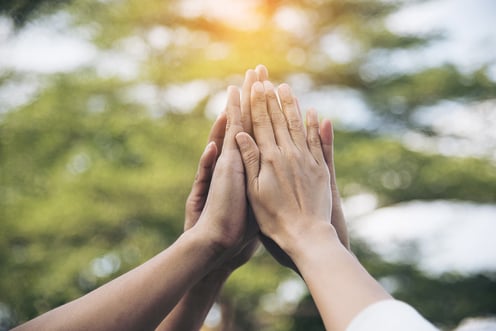 hands-together-bokeh-background