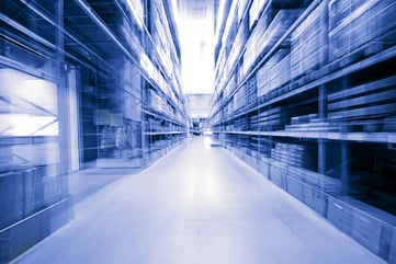 looking-down-blue-warehouse-aisle-motion-blur