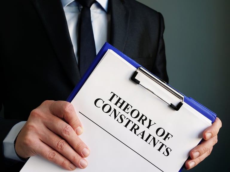 male-holding-theory-constraints-folder