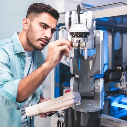 plant-worker-examining-robot-square