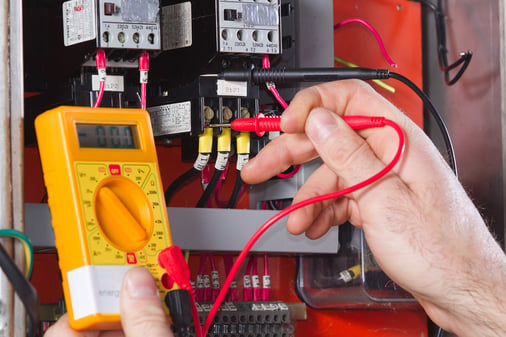 male using meter to test electrical equipment